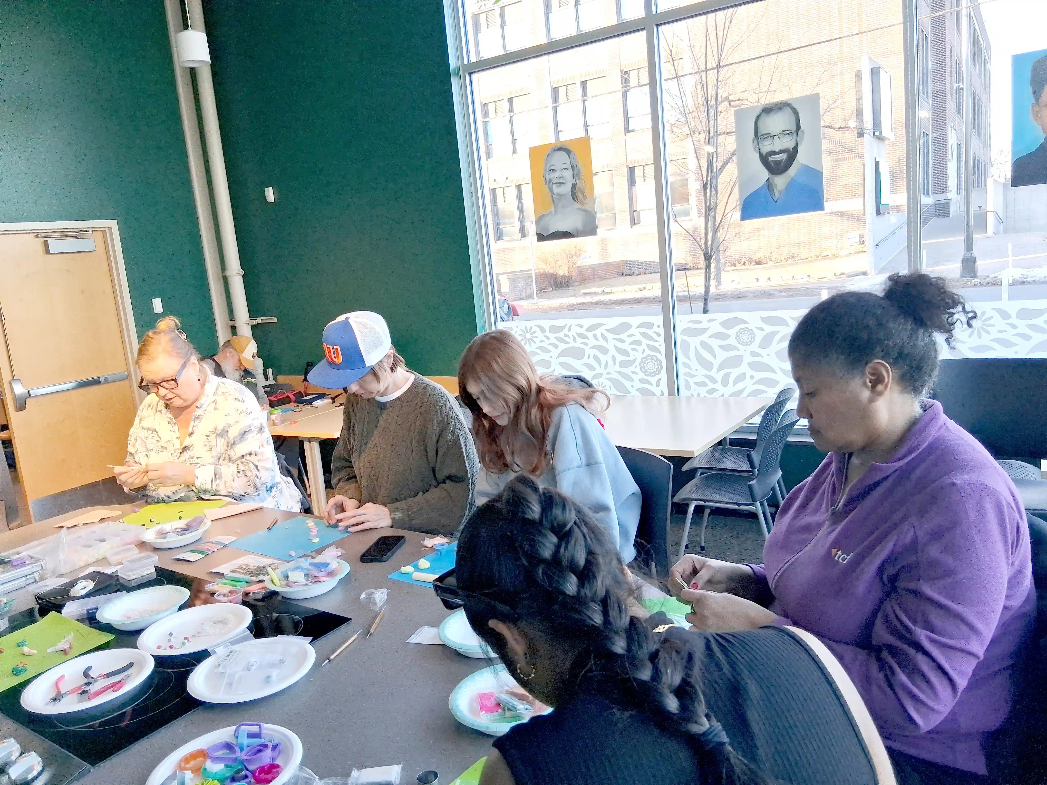 Participants working with beads and wire