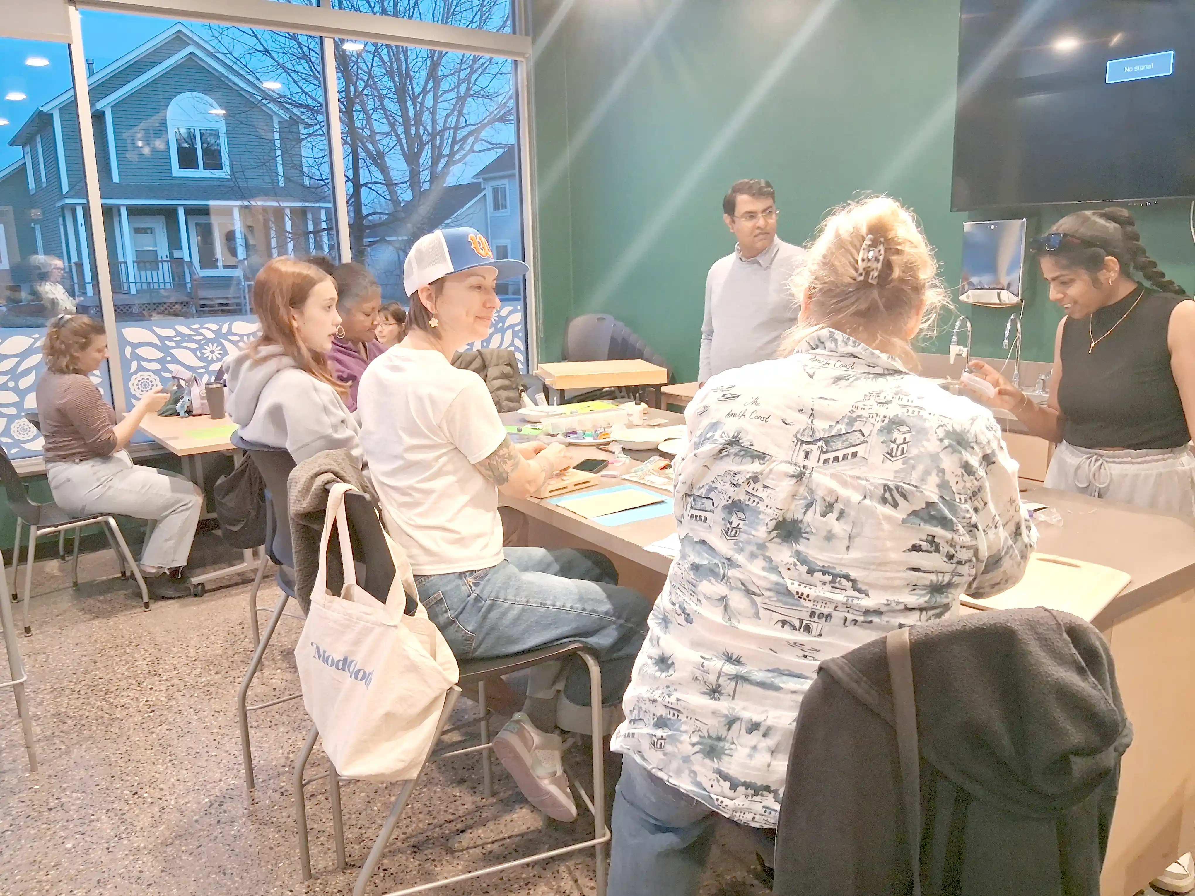Participants working with beads and wire